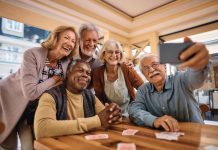 Golden Years: Senior Living Communities Cheerful senior have fun while taking selfie at retirement community.